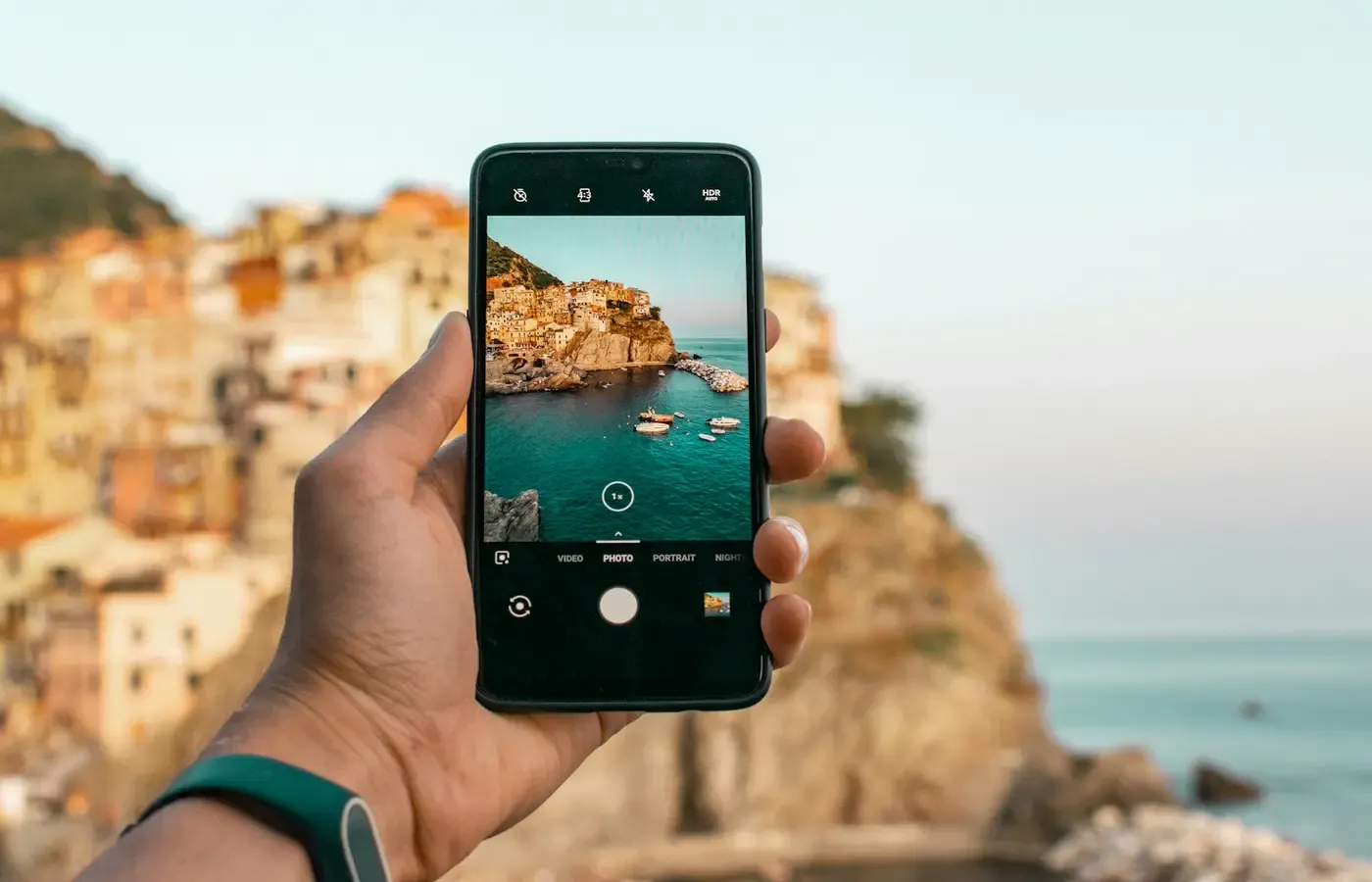 A phone beside a mirrorless camera