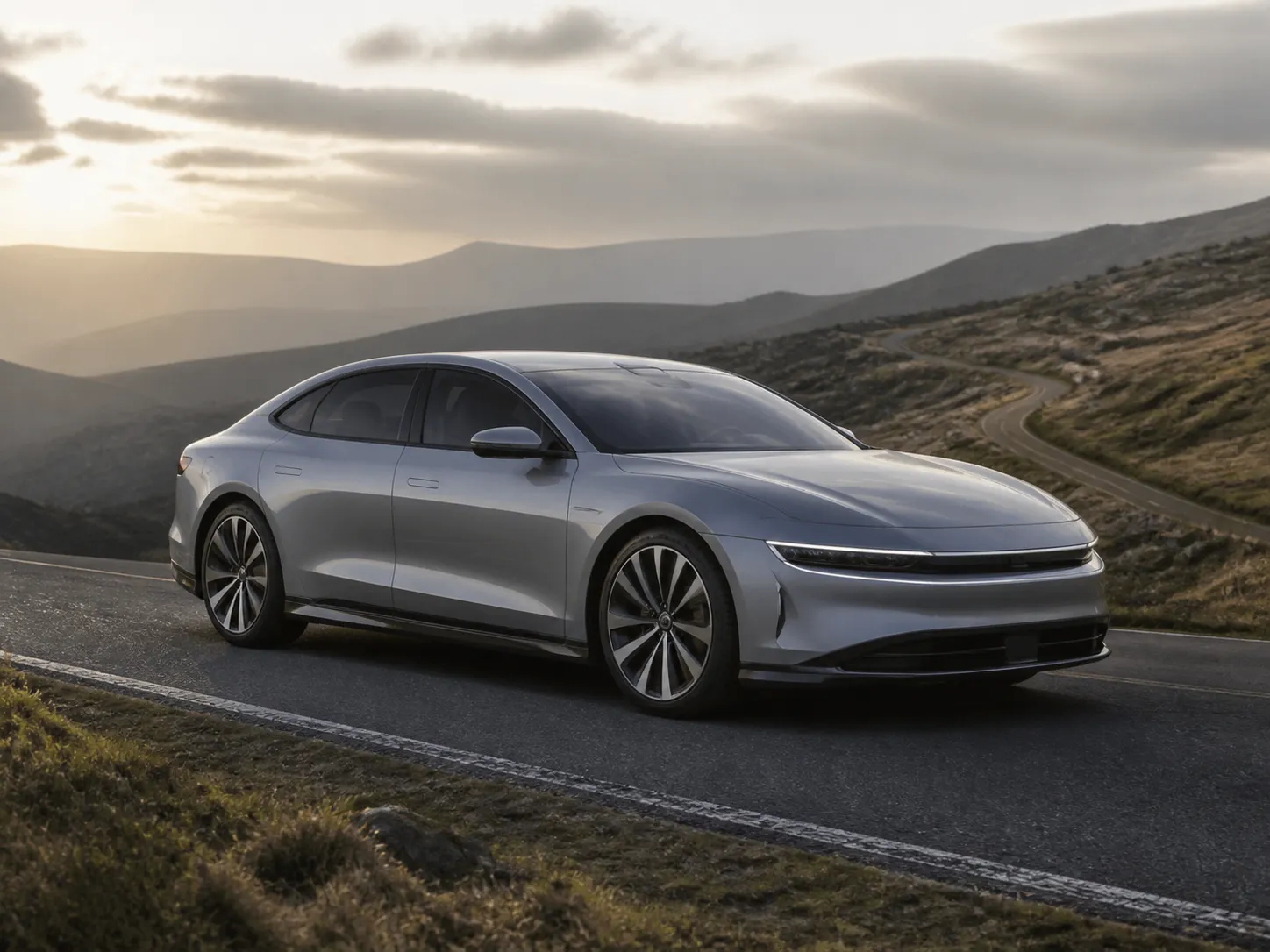 An electric car traveling through a modern landscape