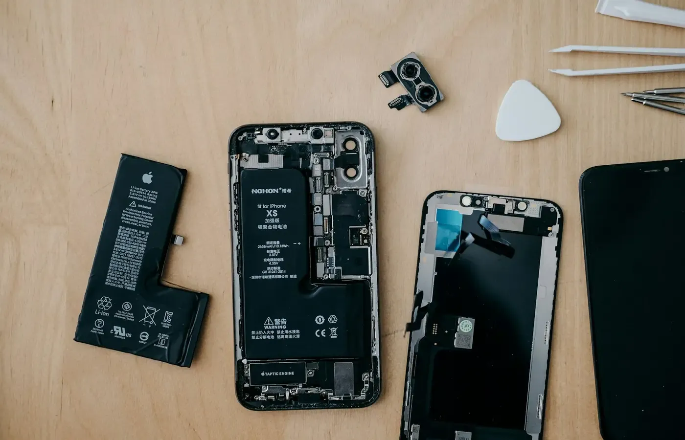 Older smartphone with battery repair tools